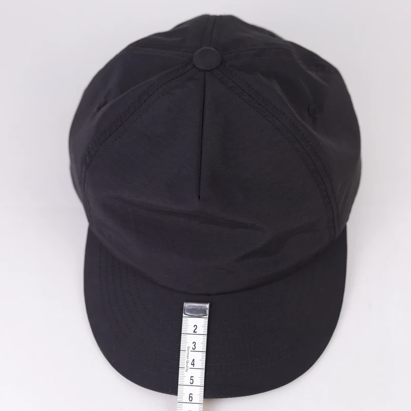 Black short-brim low-profile cap shown from the front