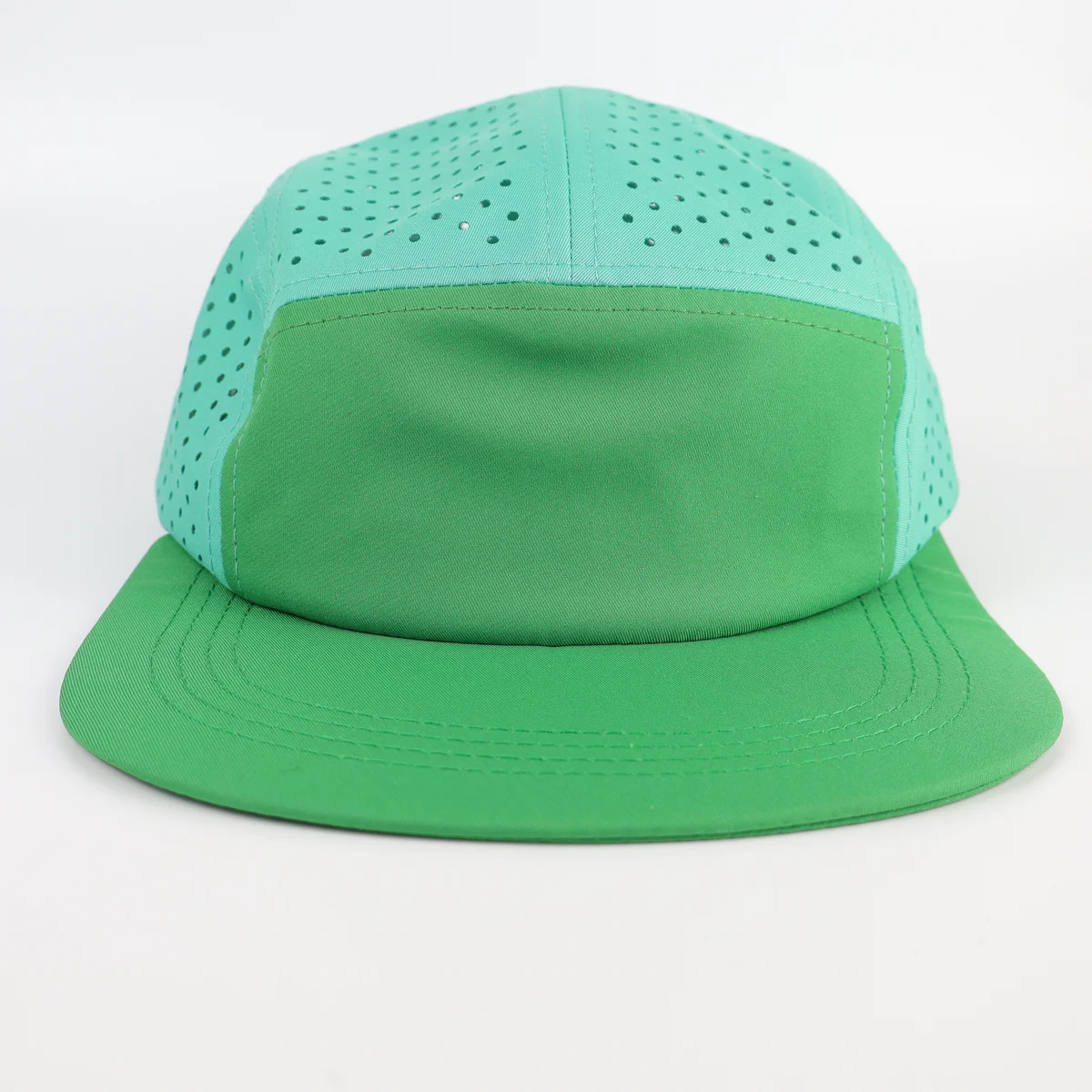 Mint green five-panel style cap with solid front panel, perforated upper crown and curved visor