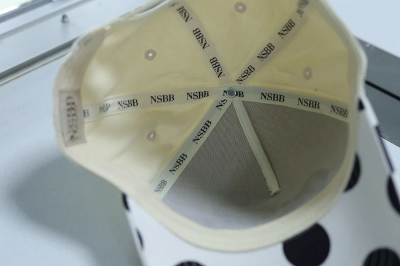 Inside view of a cream cap showing covered seams