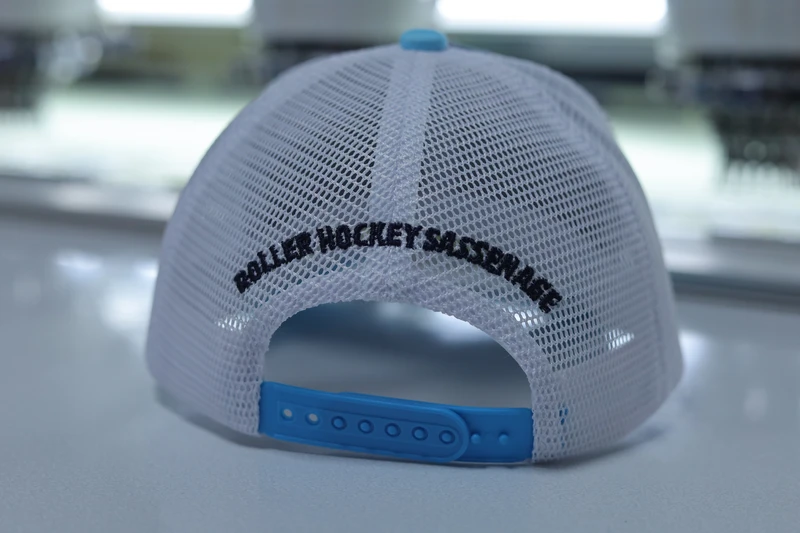 Rear view of white mesh trucker cap with blue plastic snapback closure