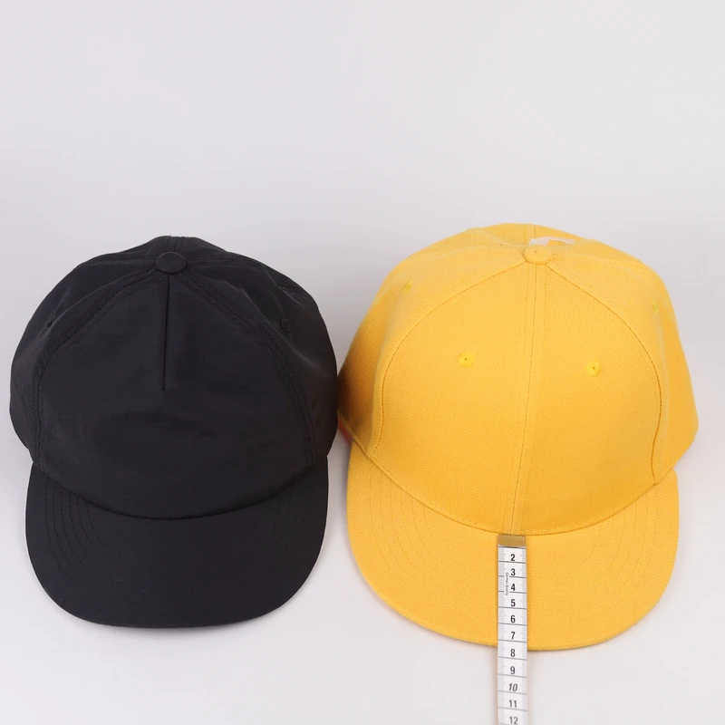 Side-by-side comparison of black short visor and larger yellow visor cap