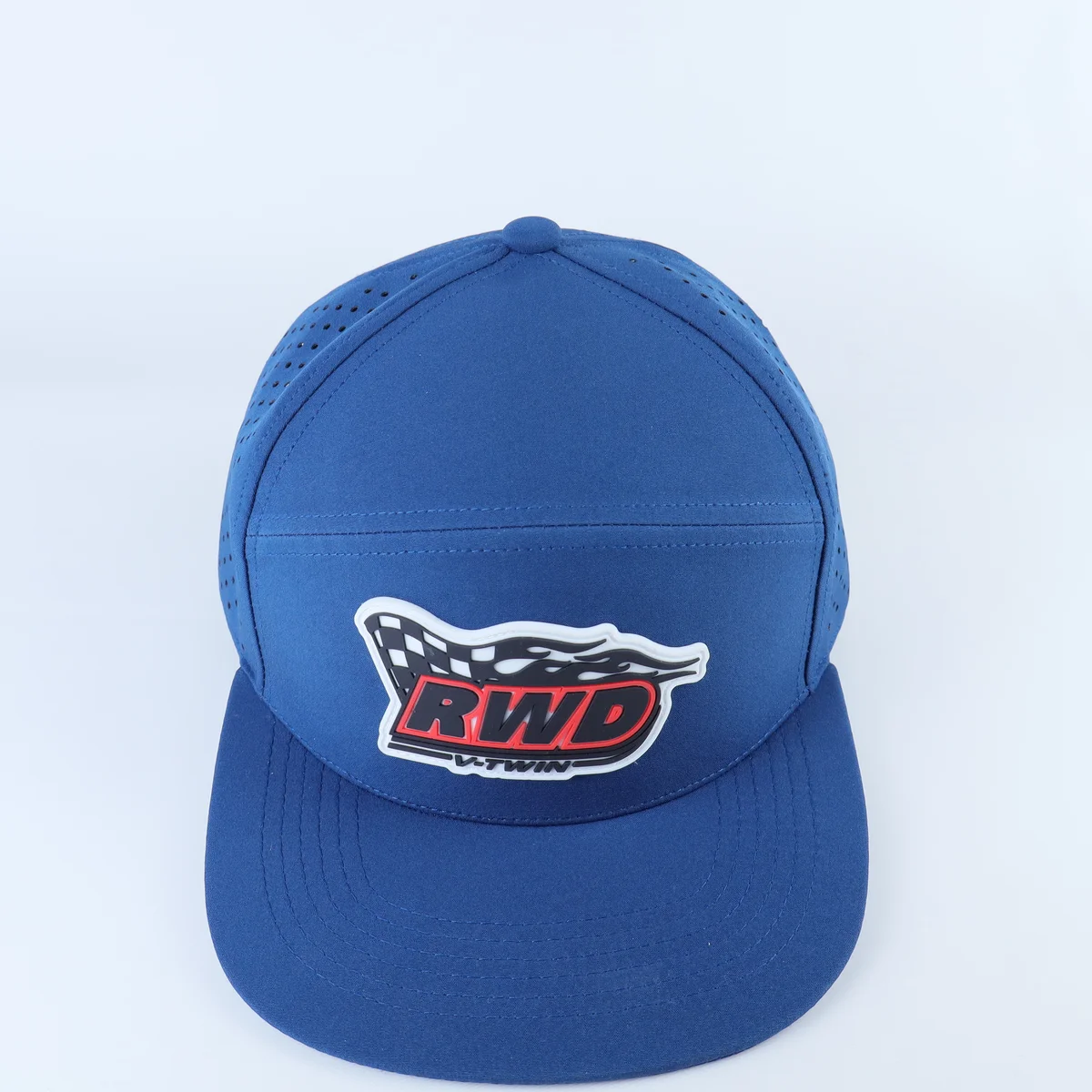 Blue perforated cap with multicolor front patch, three-quarter front view