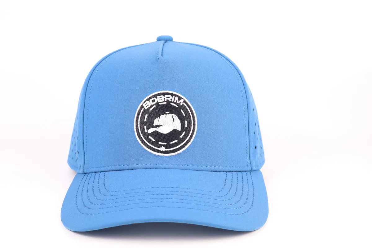 Front of blue golf cap showing circular patch, solid front panels and curved visor