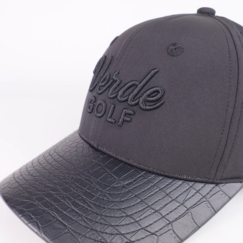 Charcoal golf cap with tonal lettering, eyelets and a patterned curved visor