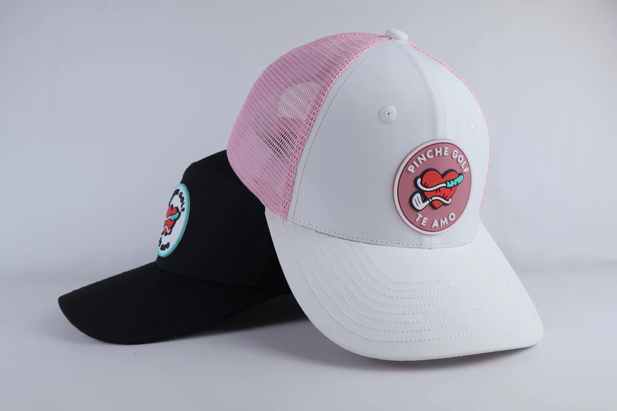 White golf cap with pink circular patch and pink perforated rear panels